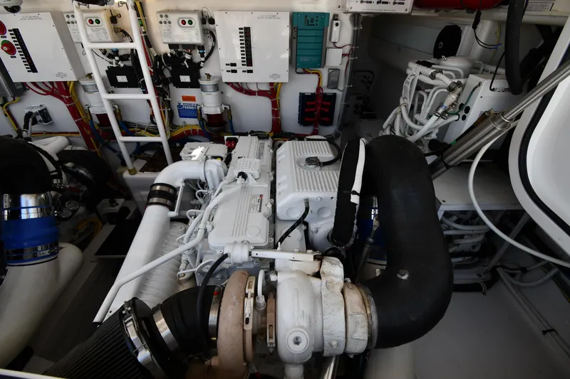Slide: The Image of Engine room of a 2012 Viking 42 Open yacht, showcasing complex machinery and control panels. - 68