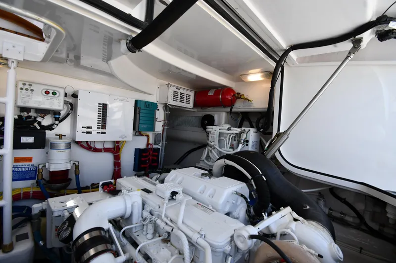Slide: The Image of Engine room of a 2012 Viking 42 Open yacht, showcasing mechanical components and systems. - 70