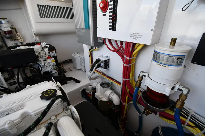 Slide: The Image of Engine room of 2012 Viking 42 Open yacht with wiring and fuel filter system. - 72