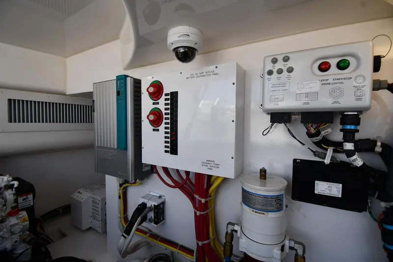 Slide: The Image of Engine room controls of a 2012 Viking 42 Open yacht, featuring electrical panels and wiring. - 75
