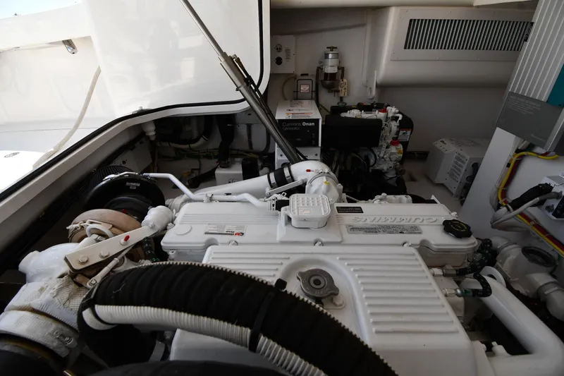 Slide: The Image of Engine room of a 2012 Viking 42 Open yacht, featuring Cummins Onan generator. - 77