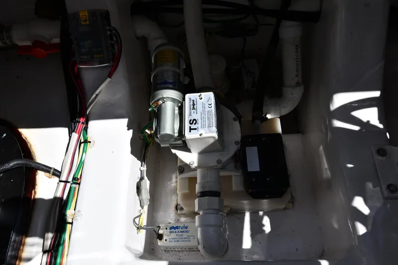 Slide: The Image of Engine compartment of a 2012 Viking 42 Open boat, showcasing wiring and pump system. - 82