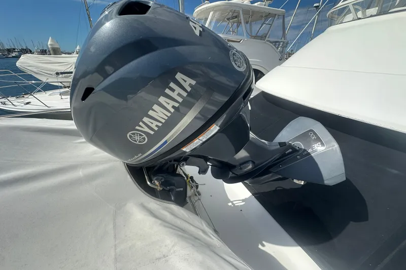 Slide: The Image of Yamaha outboard motor on a 2016 Zodiac 340 DL boat, docked at a marina. - 11