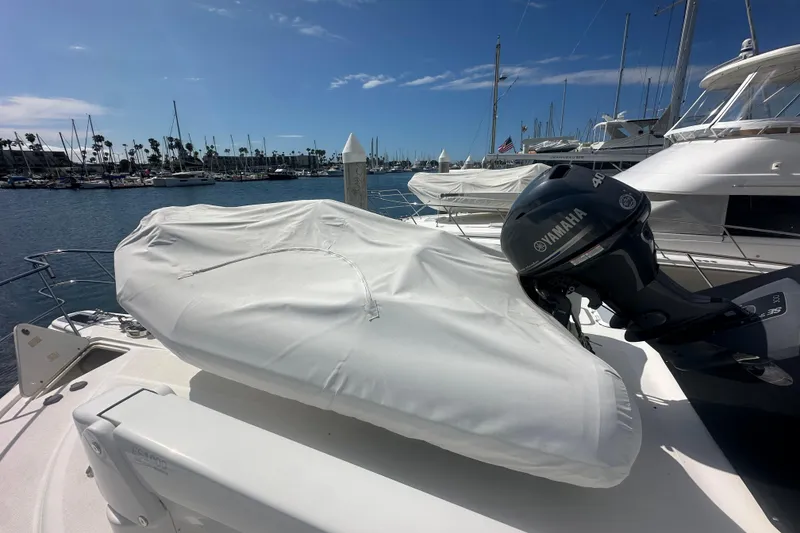 Slide: The Image of Covered Zodiac 340 DL boat with Yamaha motor docked at marina, 2016 model. - 4