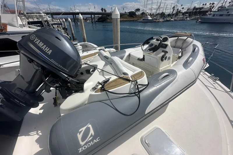 Slide: The Image of 2016 Zodiac 340 DL inflatable boat with Yamaha outboard motor docked at marina. - 5