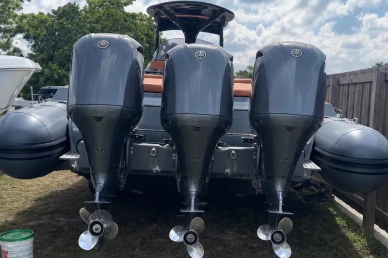Slide: The Image of 2019 SACS Strider 13 OB with triple outboard engines, parked outdoors. - 3