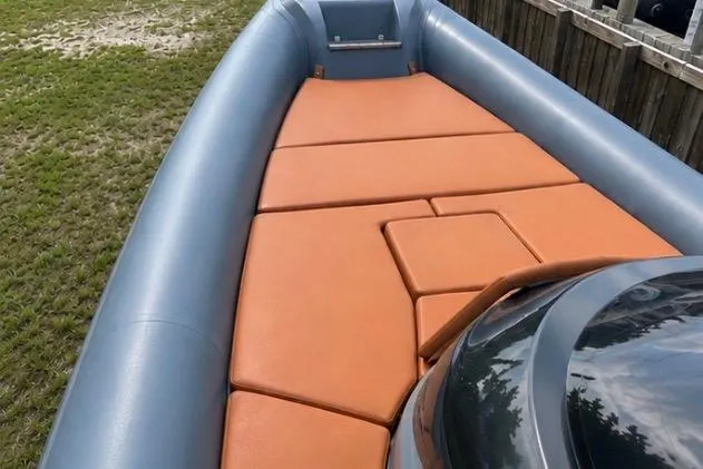 Slide: The Image of 2019 SACS Strider 13 OB boat with orange seating and gray exterior. - 4