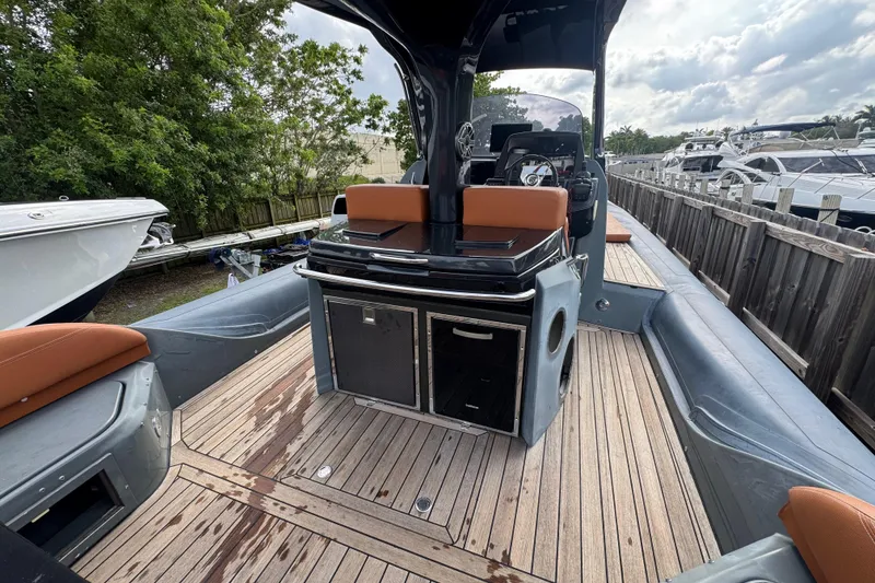 Slide: The Image of 2019 SACS Strider 13 OB boat with sleek deck and modern seating. - 7