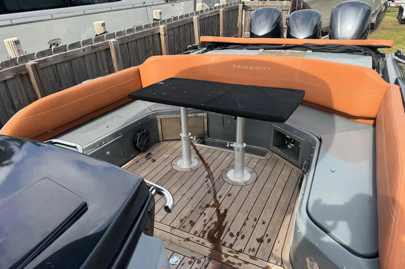 Slide: The Image of 2019 SACS Strider 13 OB boat interior with orange seating and wooden deck. - 8