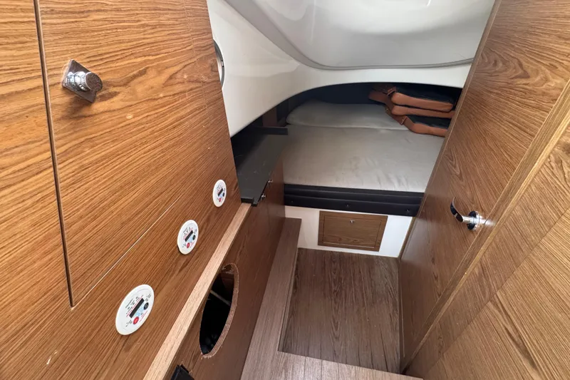 Slide: The Image of Interior cabin of 2019 SACS Strider 13 OB with wood paneling and cozy sleeping area. - 9