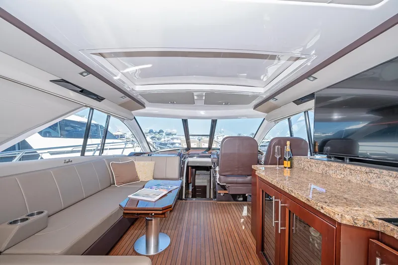 Slide: The Image of Luxurious interior of a 2015 Regal 53 Sport Coupe yacht with elegant seating and bar area. - 10
