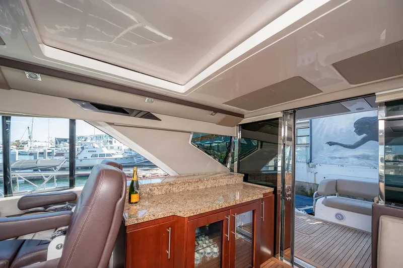 Slide: The Image of Luxurious interior of 2015 Regal 53 Sport Coupe yacht with granite countertop and marina view. - 11