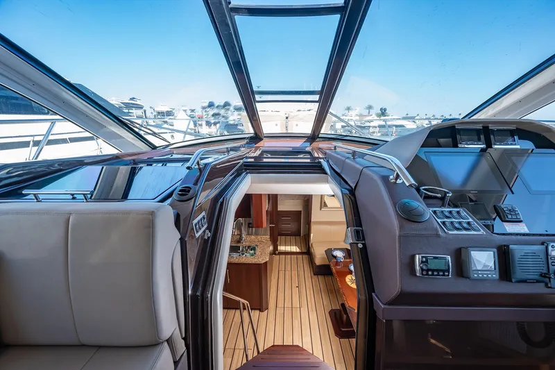 Slide: The Image of Interior view of 2015 Regal 53 Sport Coupe yacht with modern controls and seating. - 12