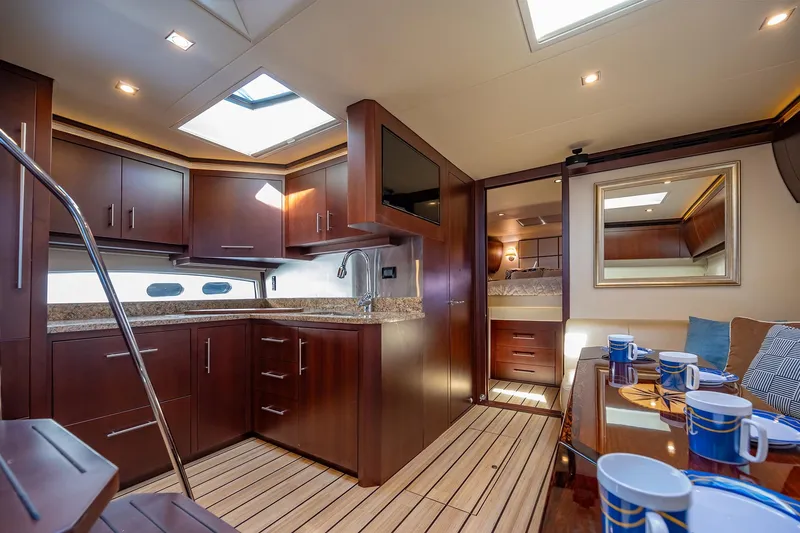 Slide: The Image of Luxurious interior of 2015 Regal 53 Sport Coupe yacht with modern kitchen and dining area. - 14