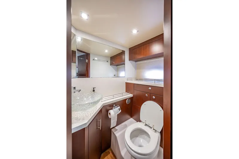 Slide: The Image of Luxurious bathroom in 2015 Regal 53 Sport Coupe yacht with modern fixtures and wood cabinetry. - 21