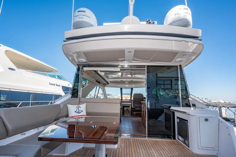Slide: The Image of Luxurious 2015 Regal 53 Sport Coupe yacht interior with seating and table. - 8