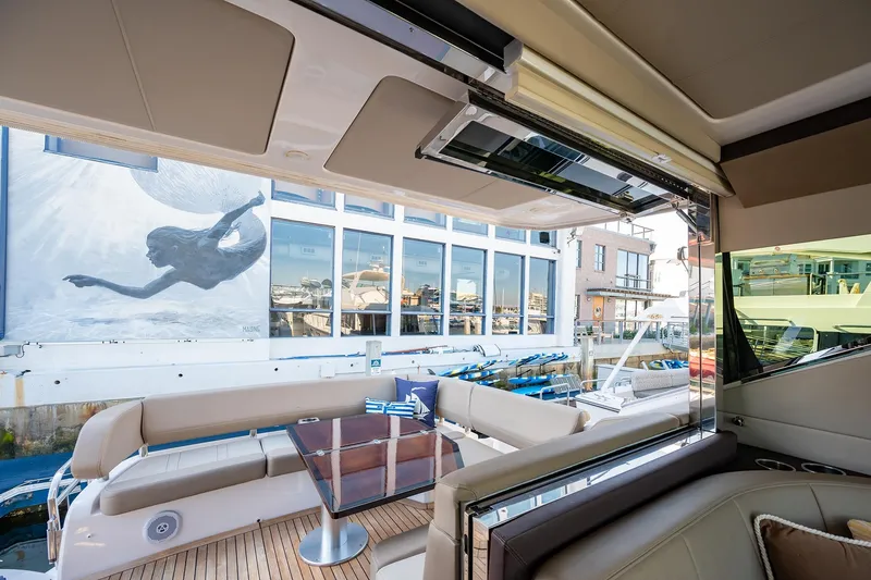 Slide: The Image of Luxurious 2015 Regal 53 Sport Coupe yacht interior with marina view and modern artwork. - 9