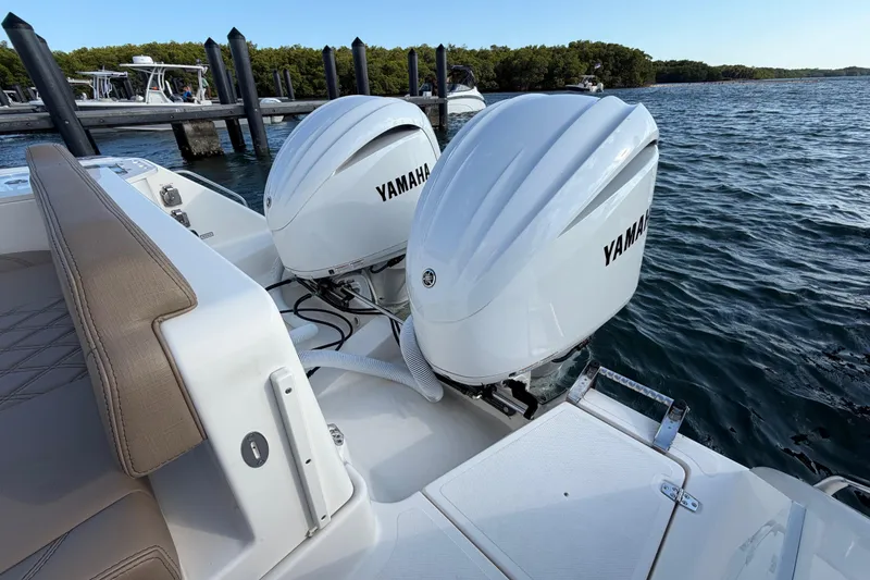 Slide: The Image of 2009 Pursuit OS 315 Offshore boat with twin Yamaha outboard engines docked by the water. - 10