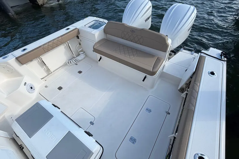 Slide: The Image of 2009 Pursuit OS 315 Offshore boat interior with seating and twin Yamaha engines. - 11