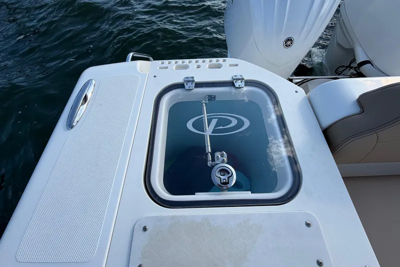 Slide: The Image of 2009 Pursuit OS 315 Offshore boat deck with hatch and engine view. - 15