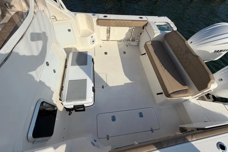 Slide: The Image of 2009 Pursuit OS 315 Offshore boat deck with seating and cooler. - 16