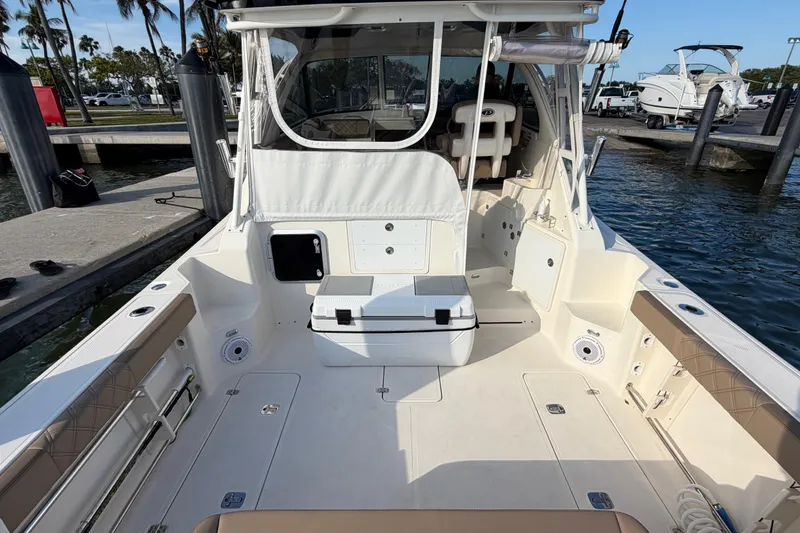 Slide: The Image of 2009 Pursuit OS 315 Offshore boat at dock, featuring spacious deck and seating area. - 17