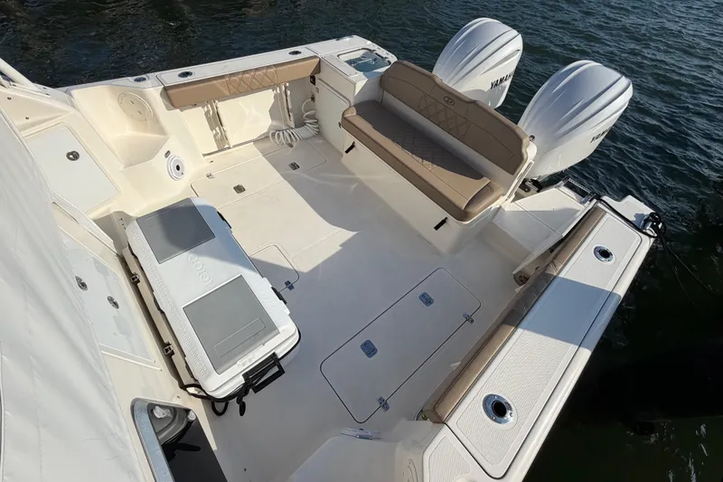 Slide: The Image of 2009 Pursuit OS 315 Offshore boat deck with seating and twin Yamaha engines. - 18