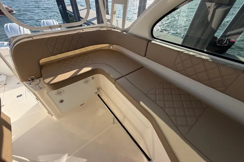 Slide: The Image of Luxurious seating on a 2009 Pursuit OS 315 Offshore boat, featuring diamond-stitched upholstery. - 25