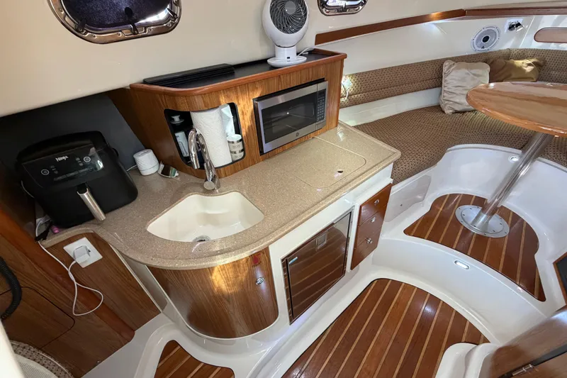 Slide: The Image of Luxurious 2009 Pursuit OS 315 Offshore yacht interior with kitchenette and seating area. - 29