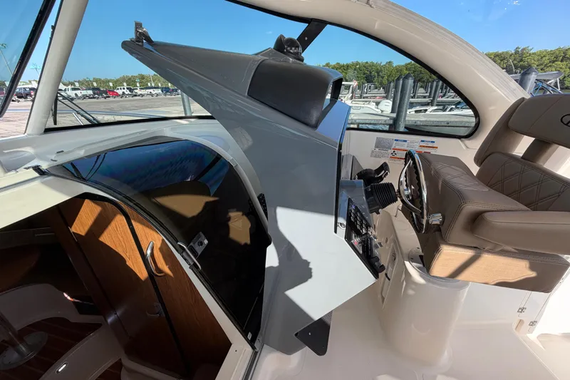 Slide: The Image of 2009 Pursuit OS 315 Offshore boat interior with helm station and cabin entrance. - 39