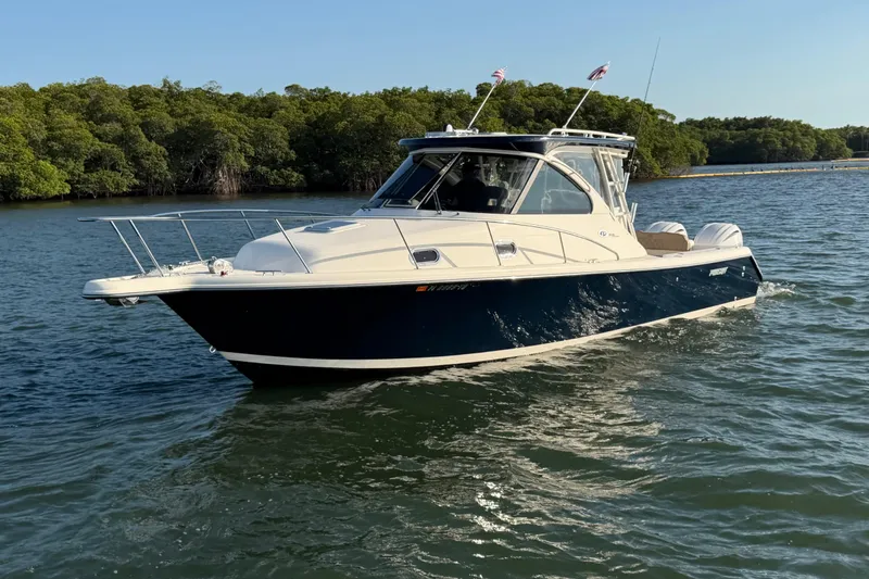 Slide: The Image of 2009 Pursuit OS 315 Offshore boat cruising on a calm waterway. - 4