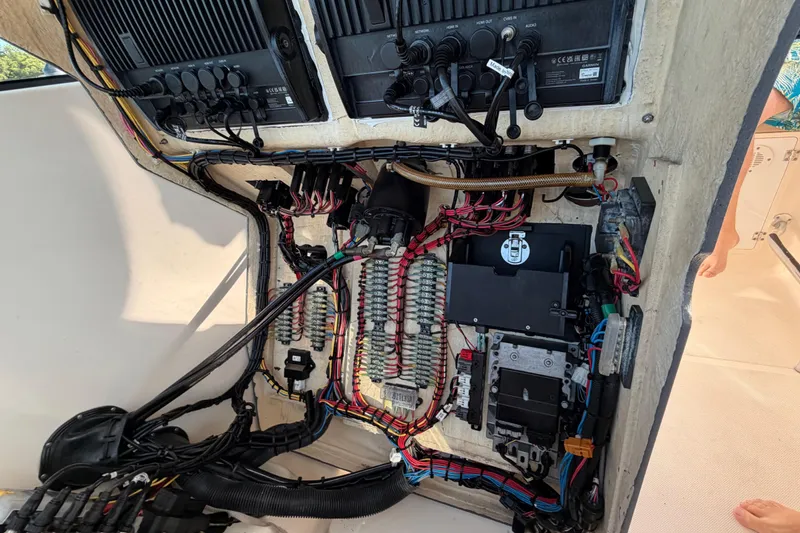 Slide: The Image of Electrical panel of a 2009 Pursuit OS 315 Offshore boat, showcasing wiring and components. - 40