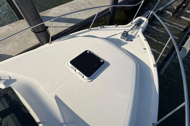 Slide: The Image of 2009 Pursuit OS 315 Offshore boat deck with hatch, docked at marina. - 46