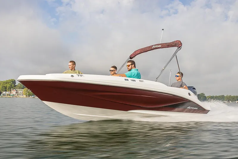Slide: The Image of Manufacturer Provided Image: 2022 Hurricane SunDeck Sport 185 OB boat cruising on a lake with four passengers. - 1