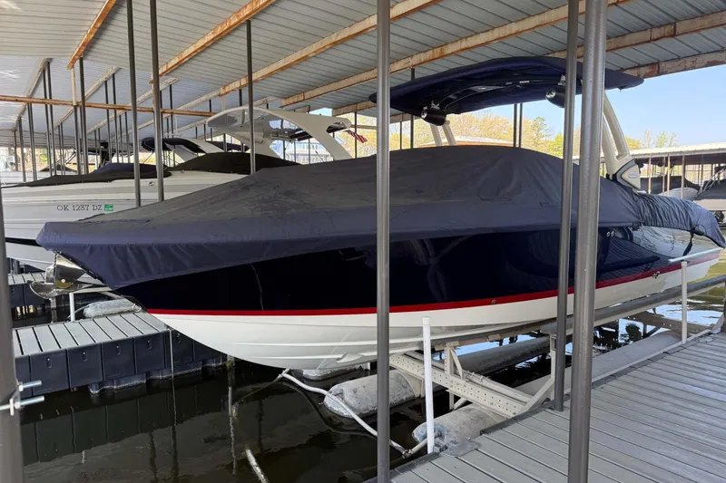 The Image of 2026 Chris-Craft Sportster 28 boat covered and docked in a marina. - 1