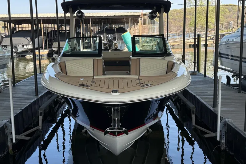 Slide: The Image of 2026 Chris-Craft Sportster 28 docked, showcasing sleek design and luxurious seating. - 11