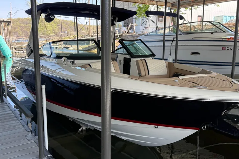 Slide: The Image of 2026 Chris-Craft Sportster 28 boat docked in a marina, showcasing sleek design and luxury features. - 12