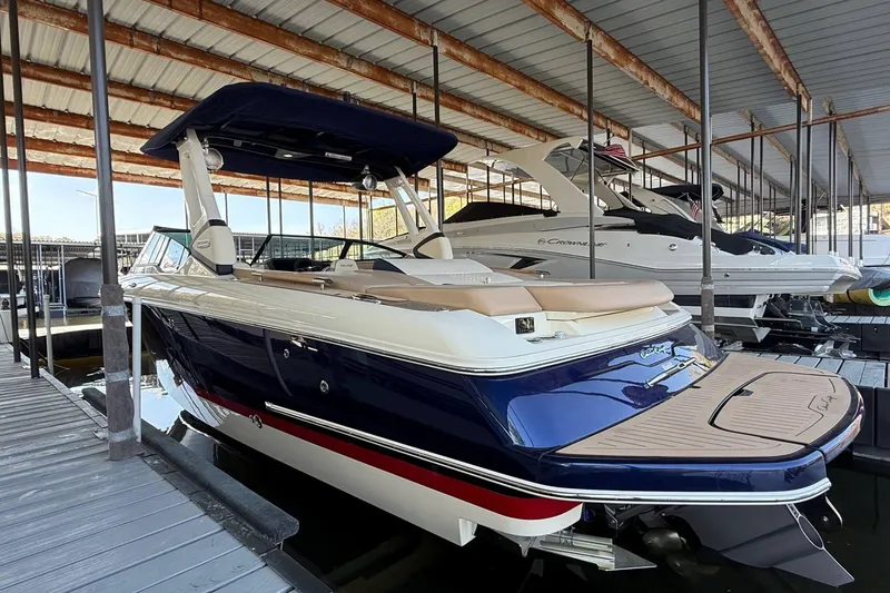 Slide: The Image of 2026 Chris-Craft Sportster 28 boat docked in a covered marina. - 6