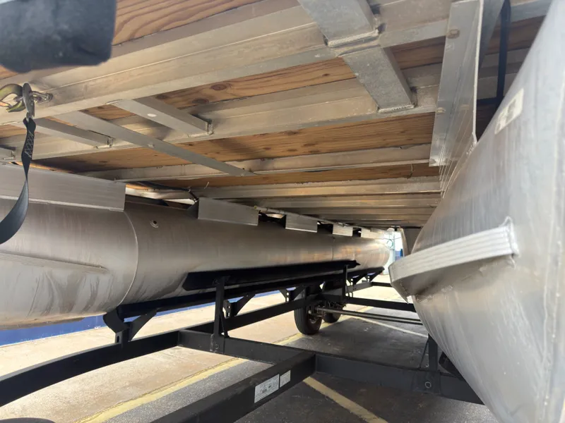 Slide: The Image of Underside of a 2020 Tracker 22DLX pontoon boat on a trailer. - 37