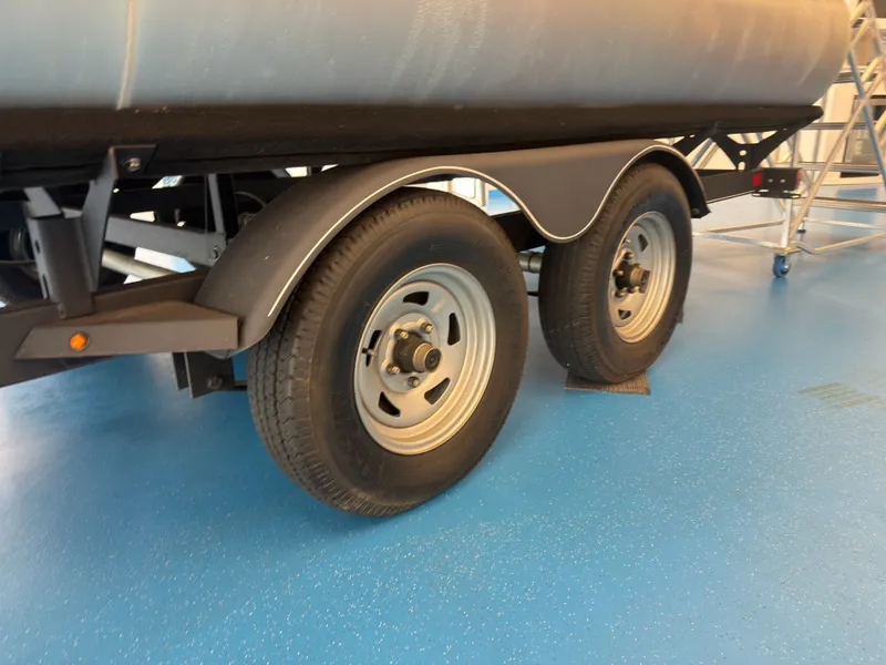 Slide: The Image of 2020 Tracker 22DLX trailer with dual wheels on blue floor. - 46