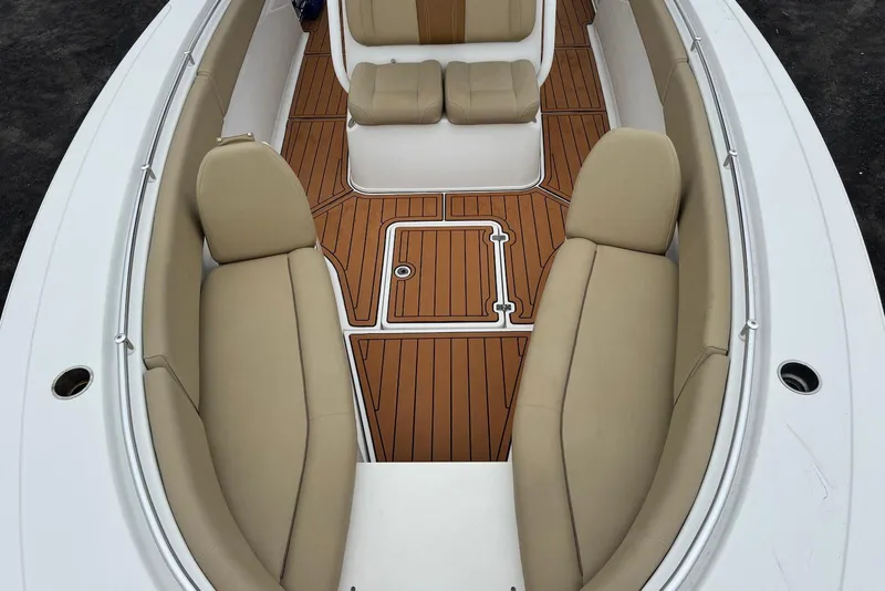 Slide: The Image of 2017 Sportsman Open 312 Center Console boat interior with tan seating and teak flooring. - 12