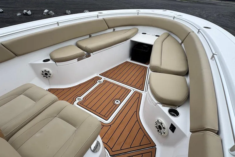 Slide: The Image of 2017 Sportsman Open 312 Center Console boat interior with tan seating and teak-style flooring. - 13