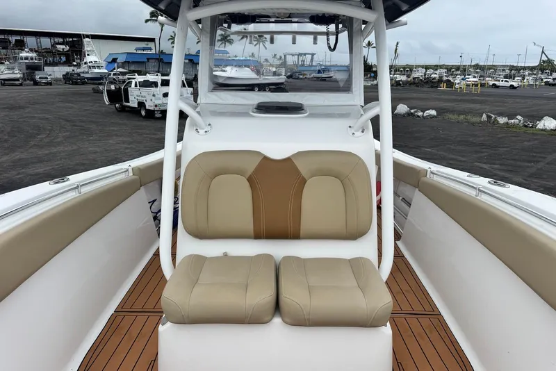 Slide: The Image of 2017 Sportsman Open 312 Center Console boat with tan seating at a marina. - 14