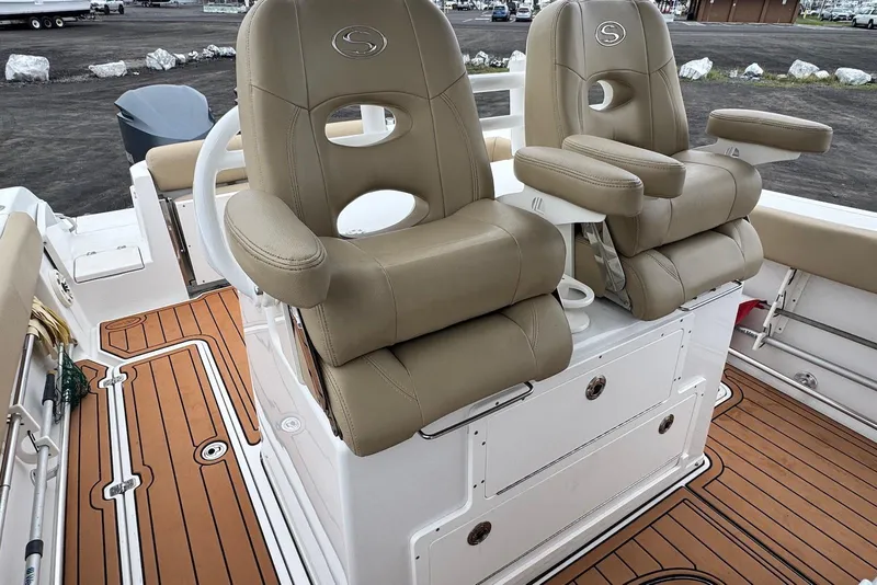 Slide: The Image of 2017 Sportsman Open 312 Center Console with tan seats and teak-style flooring. - 16