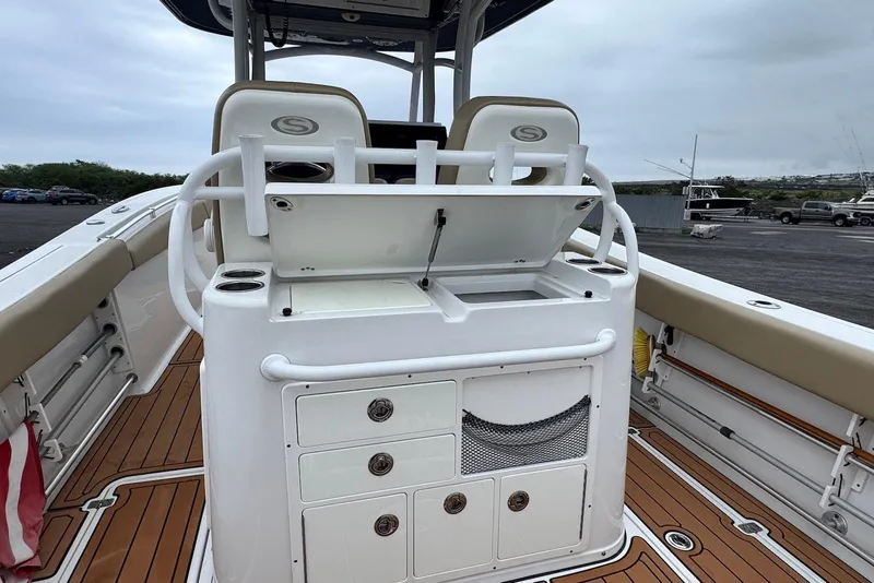 Slide: The Image of 2017 Sportsman Open 312 Center Console boat interior with storage compartments and seating. - 18
