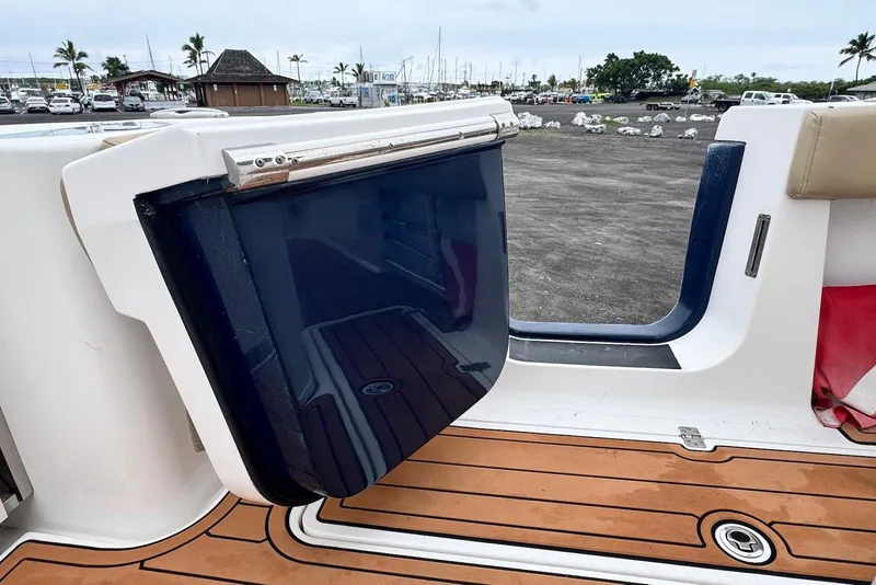 Slide: The Image of 2017 Sportsman Open 312 Center Console boat with teak flooring and open hatch. - 19