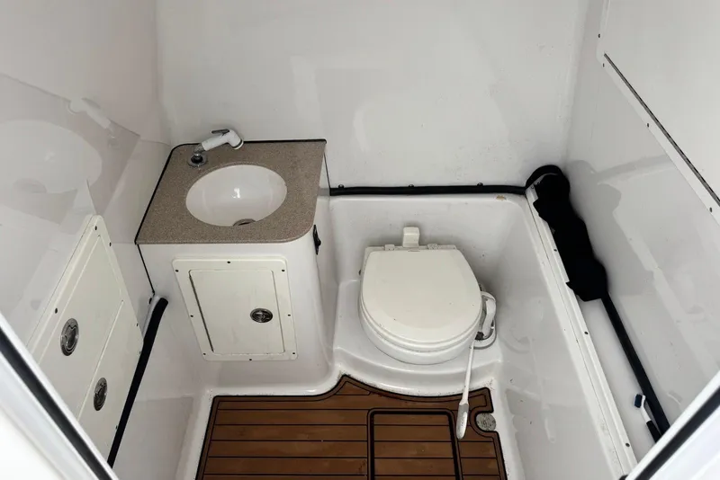 Slide: The Image of 2017 Sportsman Open 312 Center Console boat bathroom with sink and toilet. - 20