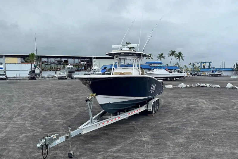Slide: The Image of 2017 Sportsman Open 312 Center Console boat on trailer in marina setting. - 4