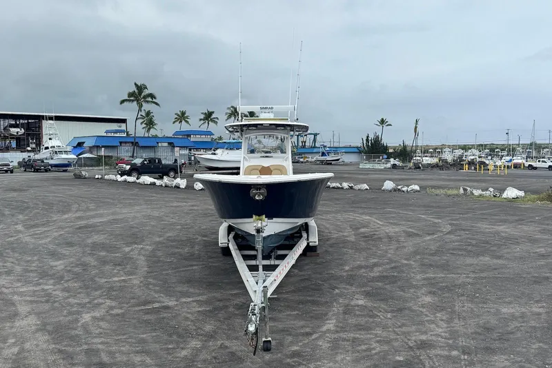 Slide: The Image of 2017 Sportsman Open 312 Center Console boat on trailer in marina lot. - 5