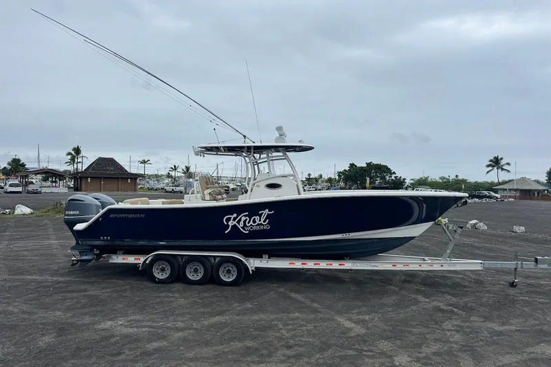Slide: The Image of 2017 Sportsman Open 312 Center Console boat on trailer, parked outdoors. - 7